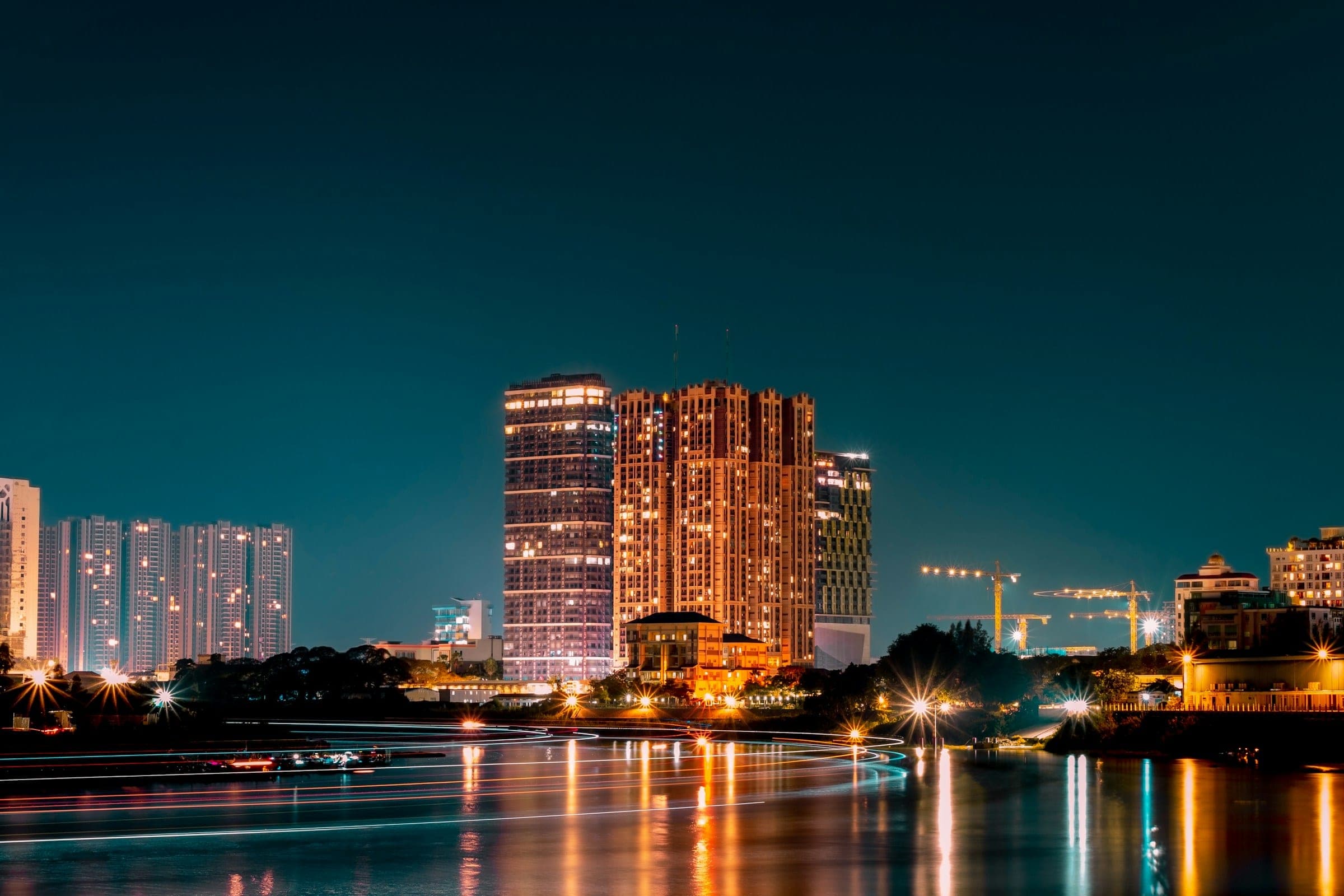 Phnom Penh at night: towers lit up along the river.